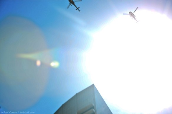 Navy helicopters flying over downtown Sydney during the International Fleet Review parade march down George Street