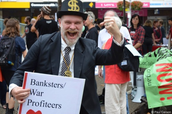 A man dressed as a 'bankster' at the Sydney March In March rally.